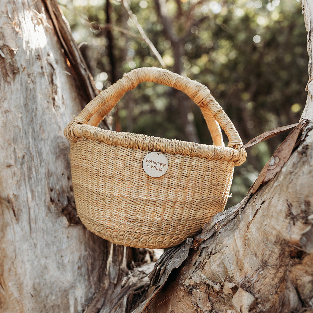 Vegan wander and wild basket sitting on tree trunk