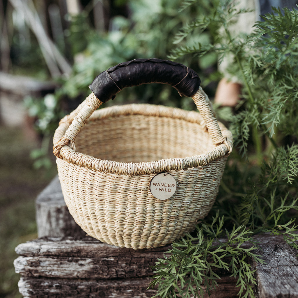 Wander and Wild woven bolga basket with black handle 