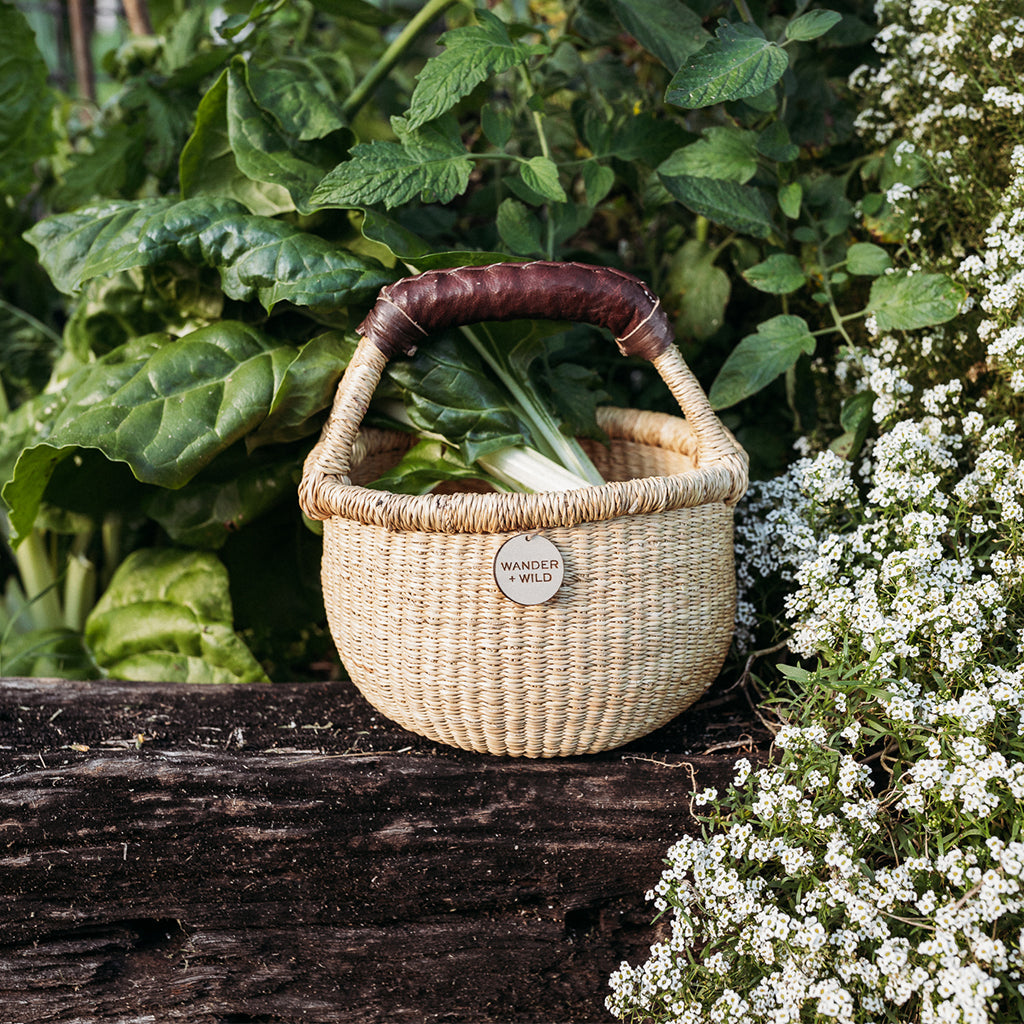 Children's play basket sitting in the garden 