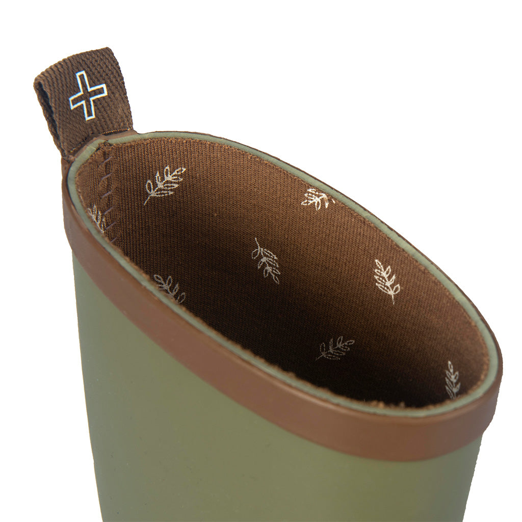 Close up of children's green gumboot featuring leaf print on soft cotton lining