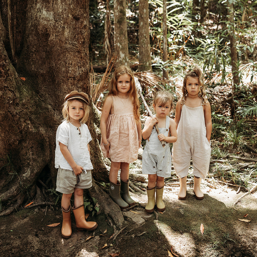 Four children exploring the rainforest with Wander and Wild kids natural rubber gumboots